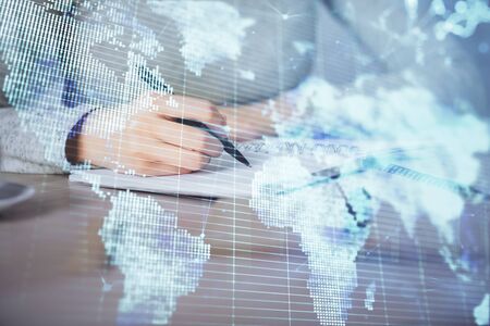International business hologram over womans hands taking notes background. Concept of success. Double exposureの写真素材