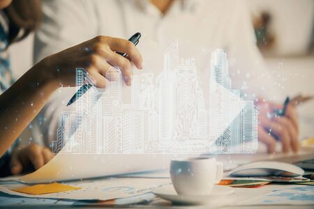 Double exposure of buildings drawing over people taking notes background. Concept of smart cityの写真素材
