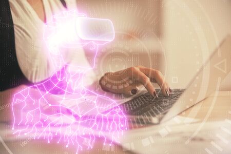 Double exposure of woman hands typing on computer and man in AR glasses drawing. Education concept.の写真素材