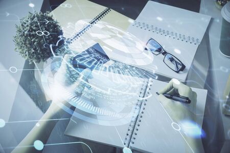 Double exposure of woman on-line shopping holding a credit card and data theme hologram drawing. E-commerce concept.の写真素材