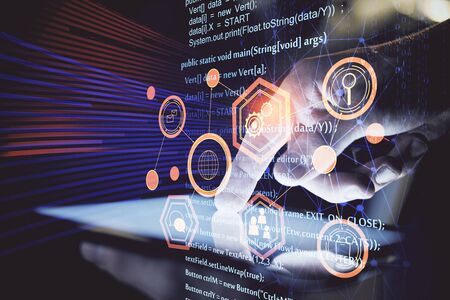 Double exposure of mans hand holding and using a digital device and data theme hologram drawing....