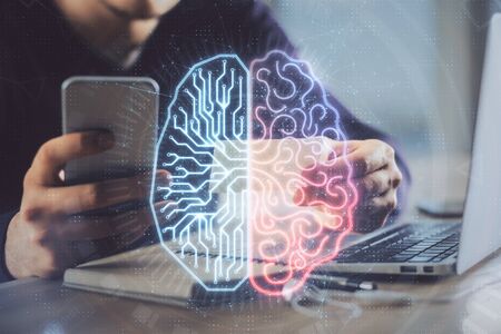 Double exposure of mans hand holding and using a digital device and brain hologram drawing. Data...