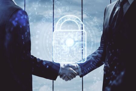 Double exposure of lock hologram and handshake of two men. Partnership security concept.