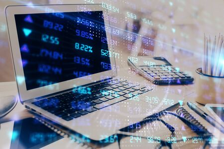 Forex market graph hologram and personal computer on background. Multi exposure. Concept of...