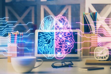 Double exposure of work space with computer and human brain drawing hologram. Brainstorm concept.