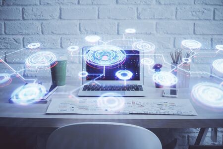 Computer on desktop with social network hologram. Multi exposure. Concept of international people connections.の写真素材