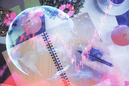 International business hologram over womans hands taking notes background. Concept of success. Double exposureの写真素材