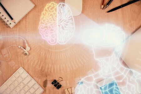 Double exposure of drawing man in AR glasses over table with phone. Top view. VR concept.の写真素材