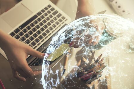 Double exposure of woman hands typing on computer and social network theme hologram drawing. People media concept.の写真素材
