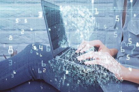 Double exposure of woman hands working on computer and data theme hologram drawing. Tech concept.