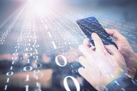 Double exposure of mans hand holding and using a digital device and data theme hologram drawing....