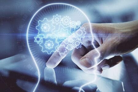 Double exposure of man's hand holding and using a digital device and brain hologram drawing. Data...