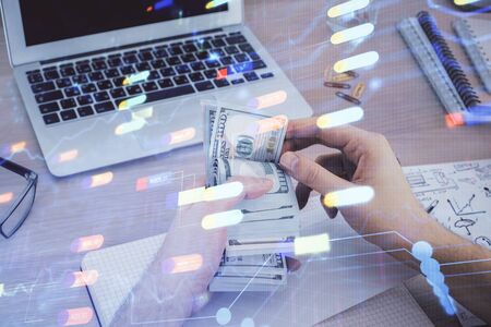 Multi exposure of technology drawing hologram and us dollars bills and man hands. Data conceptの写真素材