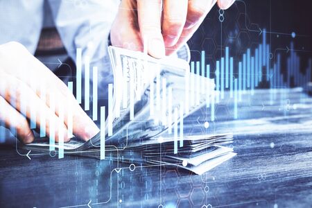 Multi exposure of forex graph drawing hologram and USA dollars bills and man hands. Technical...
