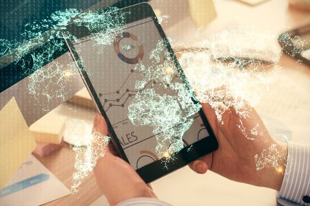 Double exposure of mans hands holding and using a phone and social network theme drawing.