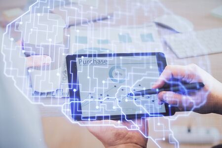 Double exposure of mans hand holding and using a digital device and brain hologram drawing. Data...