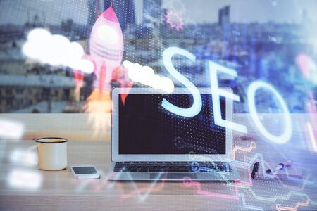 Multi exposure of table with computer and seo drawing hologram. Search optimization concept.の写真素材