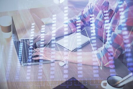 Multi exposure of forex graph with man working on computer on background. Concept of market analysis.の写真素材