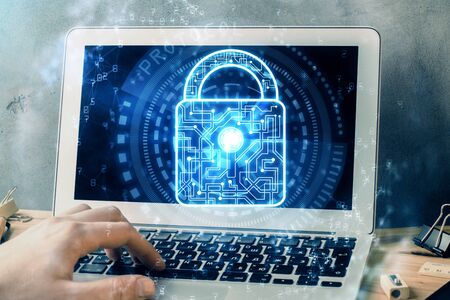 Multi exposure of lock icon with man working on computer on background. Concept of network...