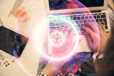 Double exposure of man's hands typing over computer keyboard and tech theme hologram drawing. Top view. Technology concept.の写真素材