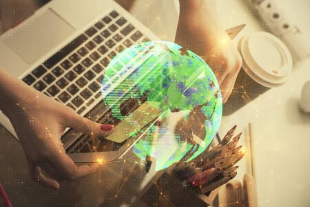 Double exposure of woman hands typing on computer and social network theme hologram drawing. People media concept.の写真素材