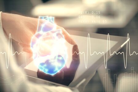 Double exposure of man's hands holding and using a phone and heart drawing. Medical education concept.の写真素材