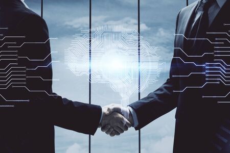 Double exposure of brain hologram and handshake of two men. Partnership in IT industry concept.の写真素材