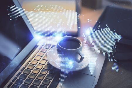 Computer on desktop with social network hologram. Multi exposure. Concept of international people connections.の写真素材