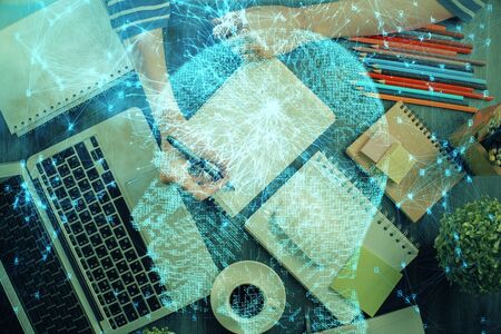 Multi exposure of writing hand on background with brain hologram. Concept of self learning.の写真素材