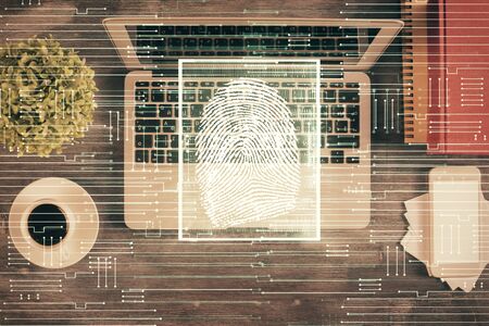 Finger print over computer on the desktop background. Top view. Double exposure. Concept of securitization.の写真素材