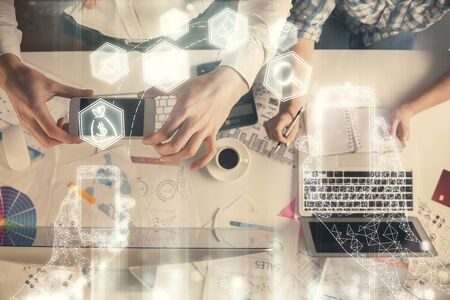 Double exposure of man and woman working together and technology theme drawing. Computer background. Top View. High tech concept.の写真素材