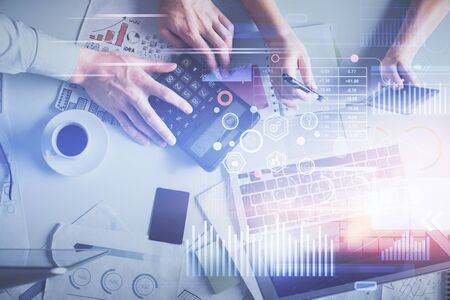 Double exposure of man and woman working together and data theme hologram drawing. Computer...
