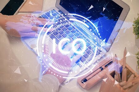 Double exposure of woman hands typing on computer and crypto market theme hologram drawing. Blockchain concept.の写真素材