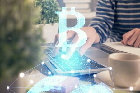 Double exposure of woman hands typing on computer and crypto market theme hologram drawing....