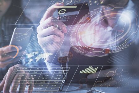 Double exposure of man and woman on-line shopping holding a credit card and data theme hologram...