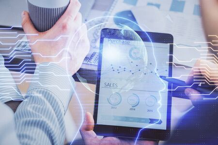 Double exposure of man's hand holding and using a digital device and brain hologram drawing. Data concept.の写真素材