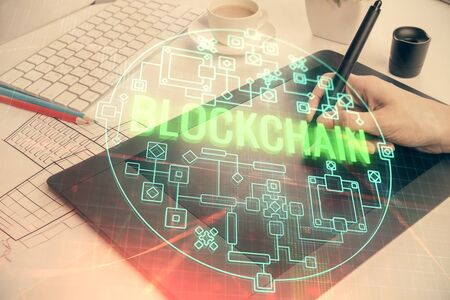 Double exposure of blockchain business sketch hologram and woman holding and using a mobile device.の写真素材