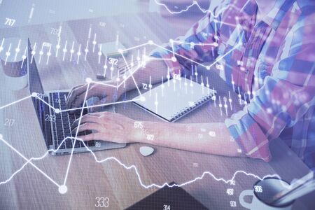 Multi exposure of forex graph with man working on computer on background. Concept of market...