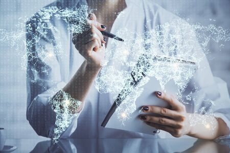 Social network theme hologram over womans hands writing background. Concept of international people connect. Double exposureの写真素材