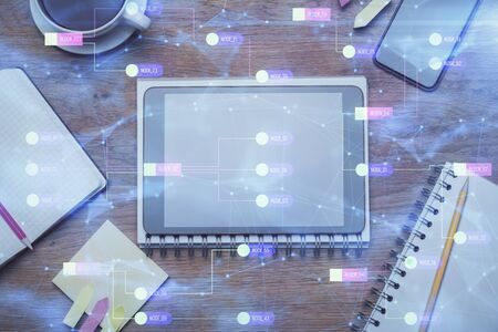 Double exposure of technology theme drawing over work table desktop. Top view. Global data analysis...