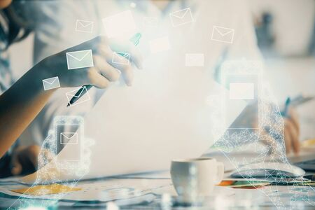 Double exposure of envelop drawing over people taking notes background. Concept of electronic connectionの写真素材