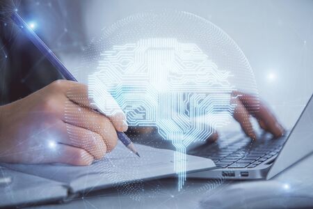 Multi exposure of woman hands working on computer and human brain hologram drawing. Ai tech concept.