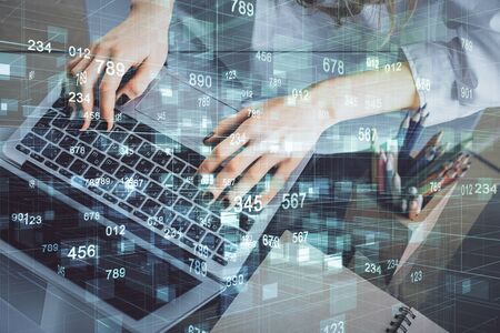 Double exposure of woman hands working on computer and data theme hologram drawing. Tech concept.の写真素材