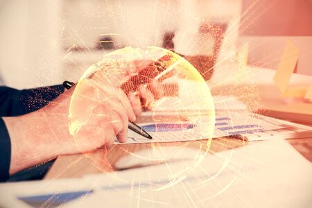 Double exposure of mans hands holding and using a phone and social network theme drawing.の写真素材