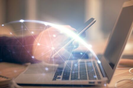 Double exposure of mans hands holding and using a phone and social network theme drawing.の写真素材