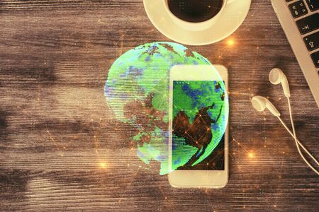 Double exposure of social network theme drawing over table with phone. Top view. People connecting concept.の写真素材