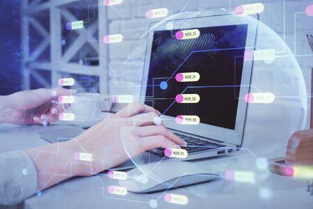 Double exposure of woman hands working on computer and data theme hologram drawing. Tech concept.