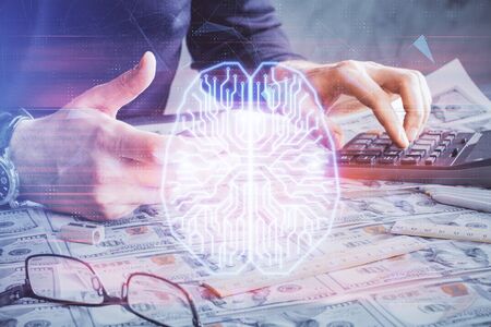 Double exposure of mans hand holding and using a digital device and brain hologram drawing. Data...