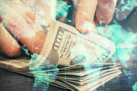 Multi exposure of financial theme drawing hologram and USA dollars bills and man hands. Business concept.の写真素材
