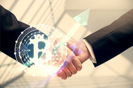 Double exposure of blockchain hologram and handshake of two men. Crypto business concept.
